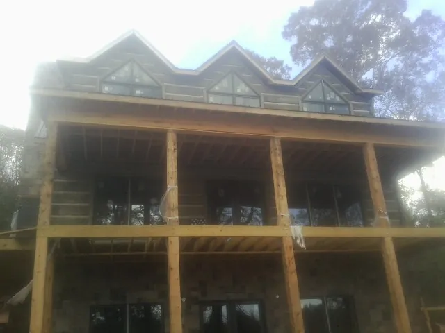 Dormers and porch framing on a large log home under construction in Del Mar