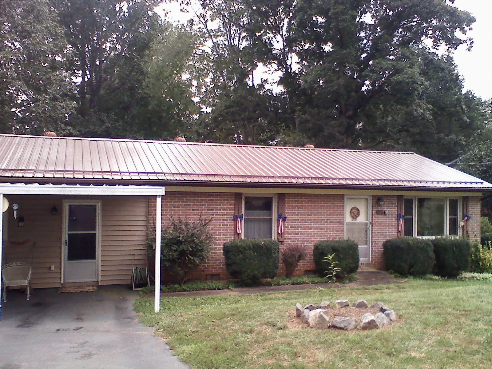 Bronze metal roof and carport on a brick ranch home — Roof Repair work by our crew in Del Mar