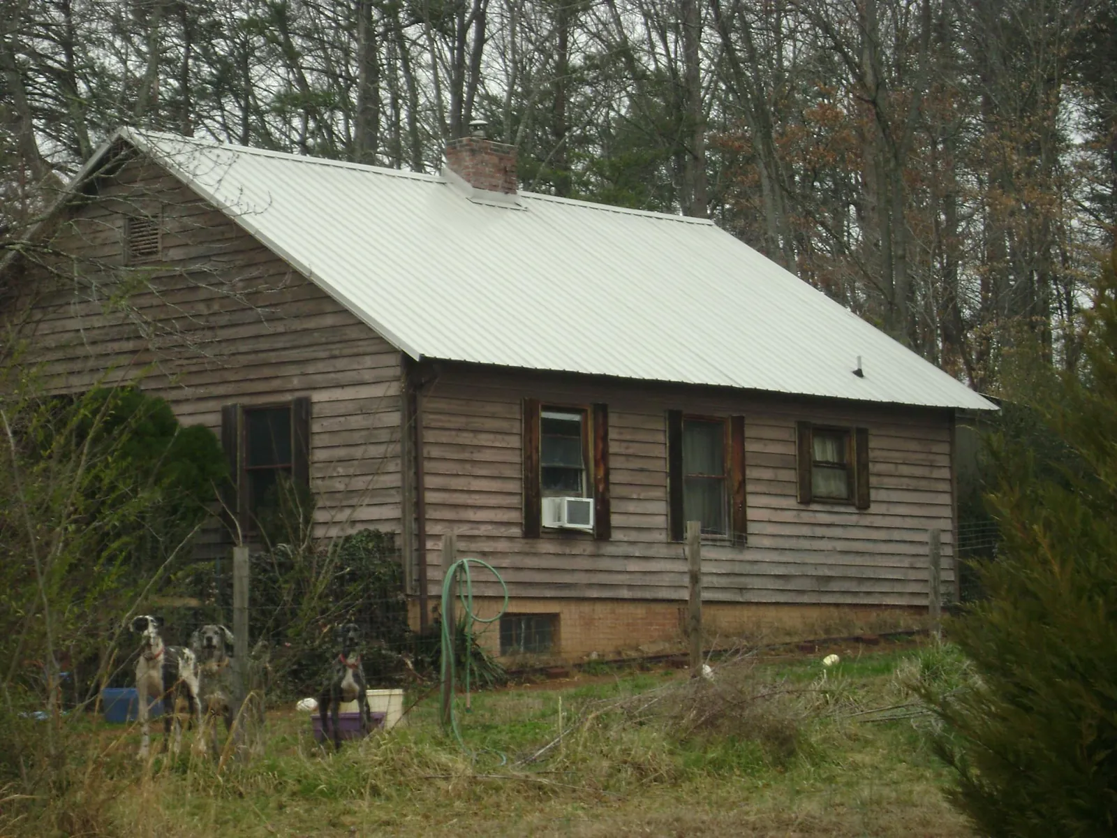 White metal roof on an old wood sided farmhouse, from a Metal Roof Installation job in Del Mar